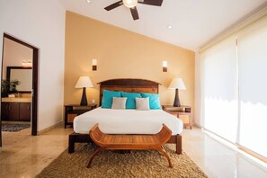 Cozy retreat with a large bed, two nightstands, and a comfortable chair.