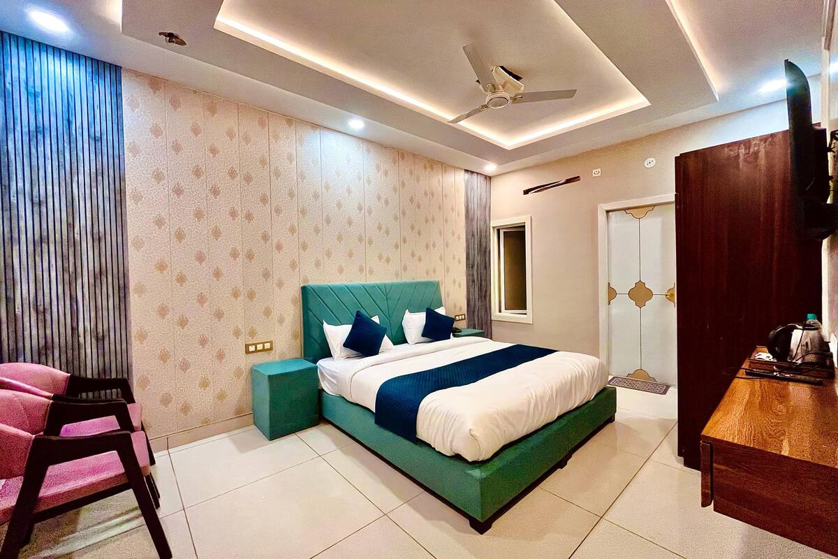 A modern bedroom with a bed, a desk, and a chair.