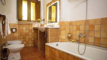 A bathroom with a toilet, sink, and bathtub.