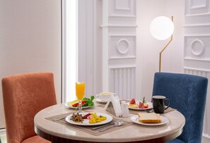 A breakfast setting with a table, chairs, and a lamp. - Nars Plus Al Naeem Hotel (Jeddah)