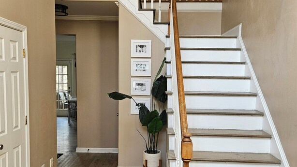 A multi-level staircase with wooden railings and white steps, leading to an upper floor. - Roswell Mini Mansion with Man Cave (Roswell)