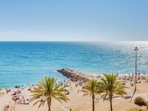 Enjoy sunbathing and relaxation on the beach with umbrellas and sun loungers.
