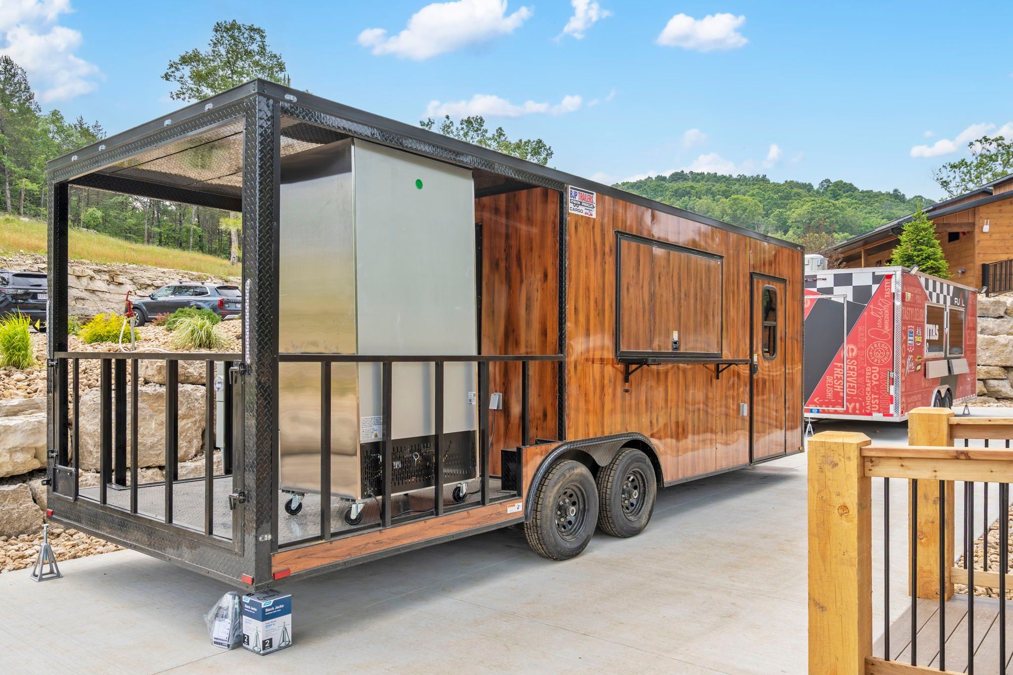 A mobile home with a metal frame, wooden exterior, and a sliding door.