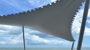 A beach umbrella with two white lounge chairs under it. - Coronado Luxury Club & Suites - swim up with golf for 2 and resort amenities! (Panamá Oeste Province)