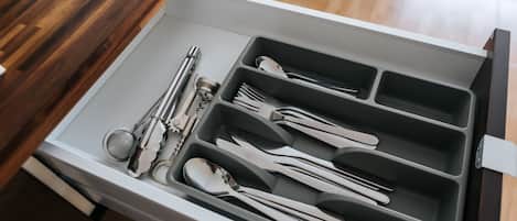 A drawer with utensils neatly organized in compartments.