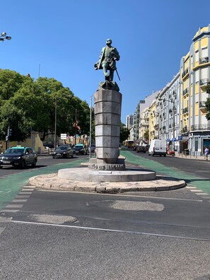 A statue on a pedestal in a city square with buildings in the background. - Downtown Lisbon Arroios Flat 3 (Lisbon)