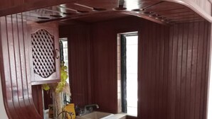 Eine kleine Küche mit Holzverkleidung, einem Spülbecken und einem Fenster.