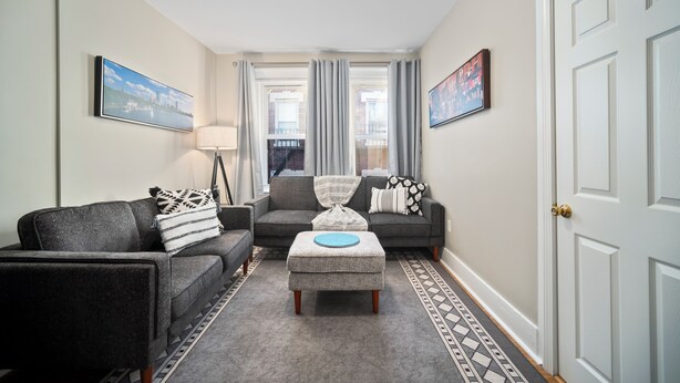 A living room with two sofas, a coffee table, and a patterned rug. - Prima Boston North End 2brm (Boston)
