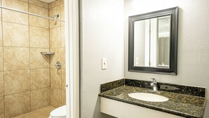 A bathroom with a shower, toilet, sink, and mirror. - Villa Motel (Santa Maria)