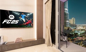 Enjoy a city view from the balcony, featuring a flat-screen TV and a comfortable seating area.