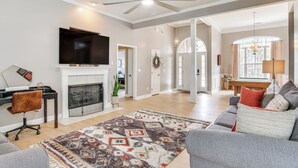 A spacious living room with a fireplace, a flat-screen TV, and a comfortable seating area. - Tee Off in Augusta: Masters Retreat w/ Patio (Graniteville)