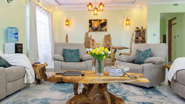 A living room with two sofas, a coffee table, and a painting on the wall.