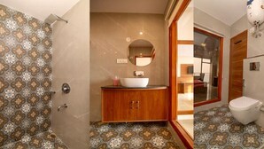 A bathroom with a wooden vanity, a white sink, and a toilet. - Shimla Inn (Shimla)