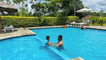 Outdoor pool, open 7:00 AM to 9:00 PM, pool umbrellas, pool loungers