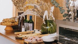 A kitchen counter with various food items, a cutting board, and kitchen utensils. - Dreamsea Gran Canaria Boutique (Moya)