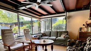 A sunlit room with a ceiling fan, a sofa, a chair, and a coffee table. - Holiday Home for 6 in Sint Maartenszee (Sint Maartensvlotbrug)