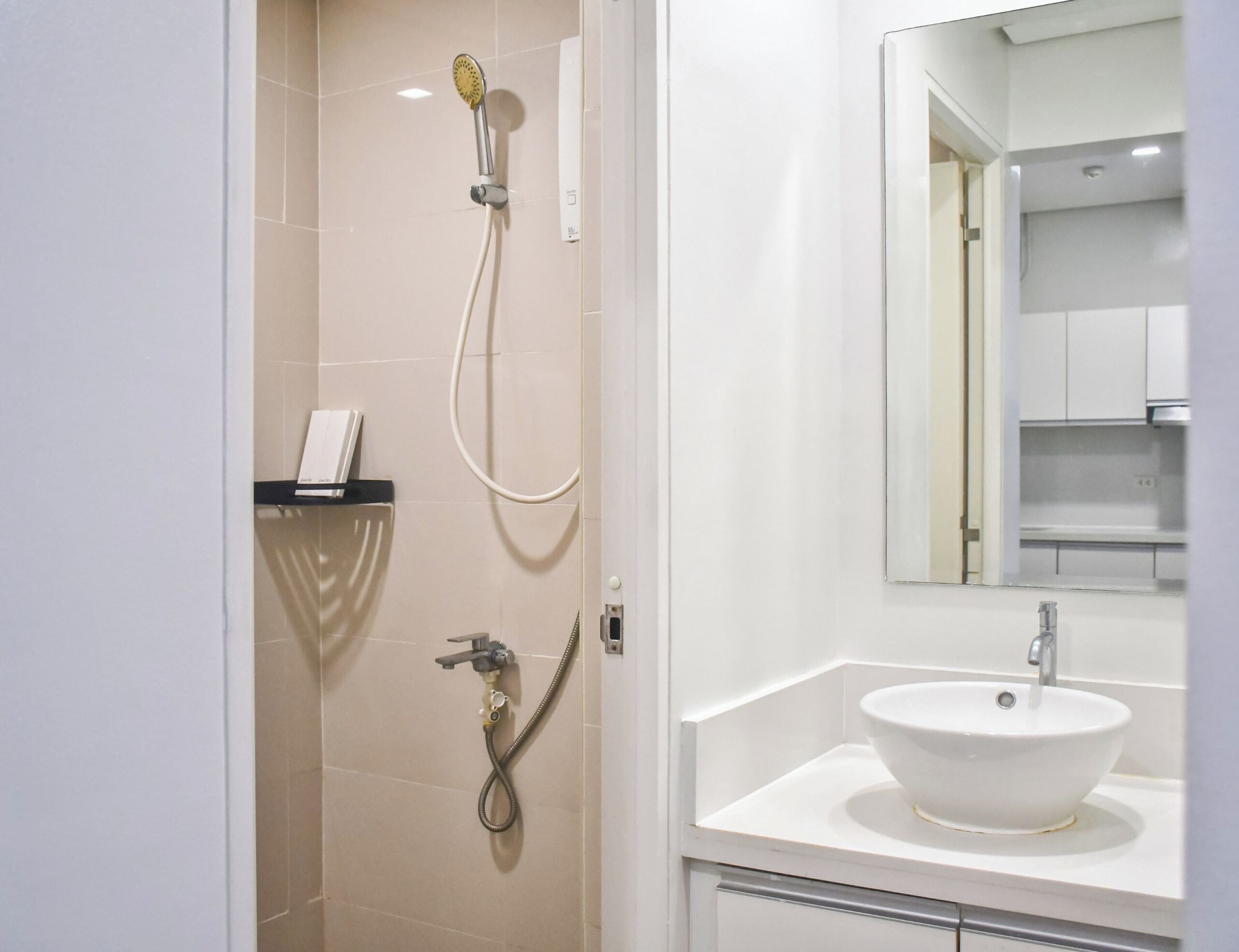 A bathroom with a shower, a sink, and a mirror.