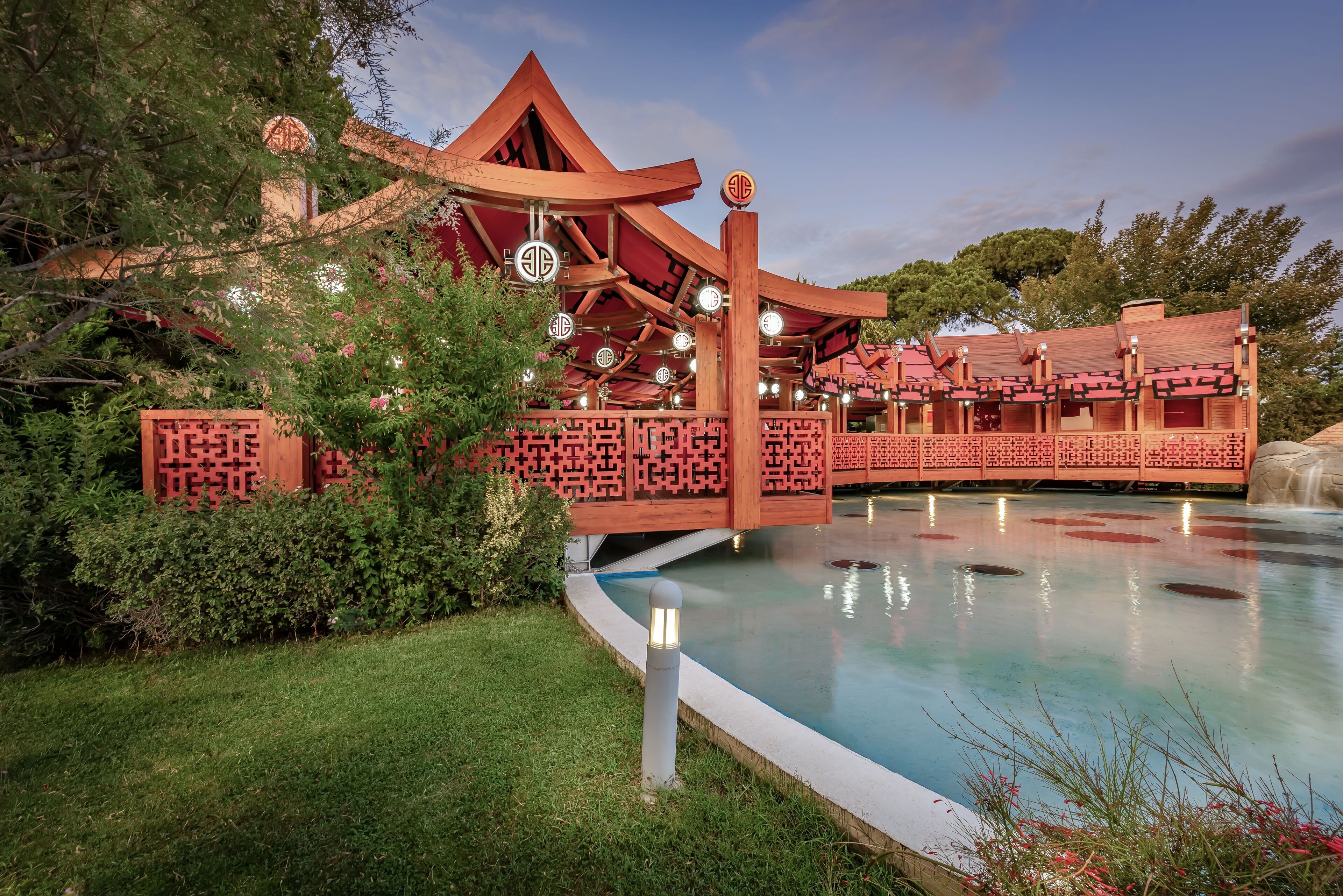 A traditional Chinese pavilion with a pool in front.