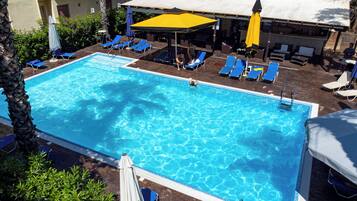 Seasonal outdoor pool, open 11:00 AM to 8:00 PM, pool umbrellas
