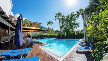 Seasonal outdoor pool, open 11:00 AM to 8:00 PM, pool umbrellas