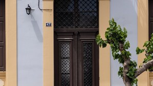 A building with a double door, a small tree in front, and a number '47' sign. - Bouquet Luxury Rooms (Chania)