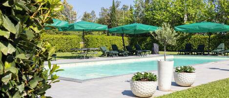 Seasonal outdoor pool, open 8:00 AM to 8:30 PM, pool umbrellas
