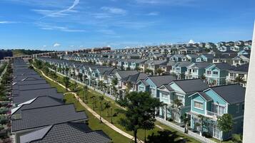 A residential area with rows of houses featuring gabled roofs and white picket fences.