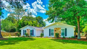 A two-story house with a well-maintained lawn and trees. -  Goshen Lake Golf Club Retreat (Augusta)