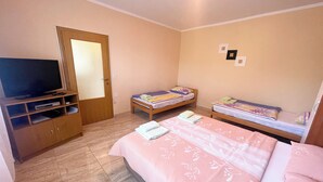 A bedroom with a bed, a TV, and a wooden cabinet. - Apartment Combaj 3 (Jadranovo)