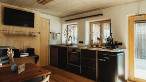 A modern kitchen with wooden cabinetry, a built-in oven, and a dishwasher.