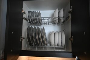 An open dishwasher with multiple racks holding plates and bowls. - Athenian Stay 303 Apartment (Athens)