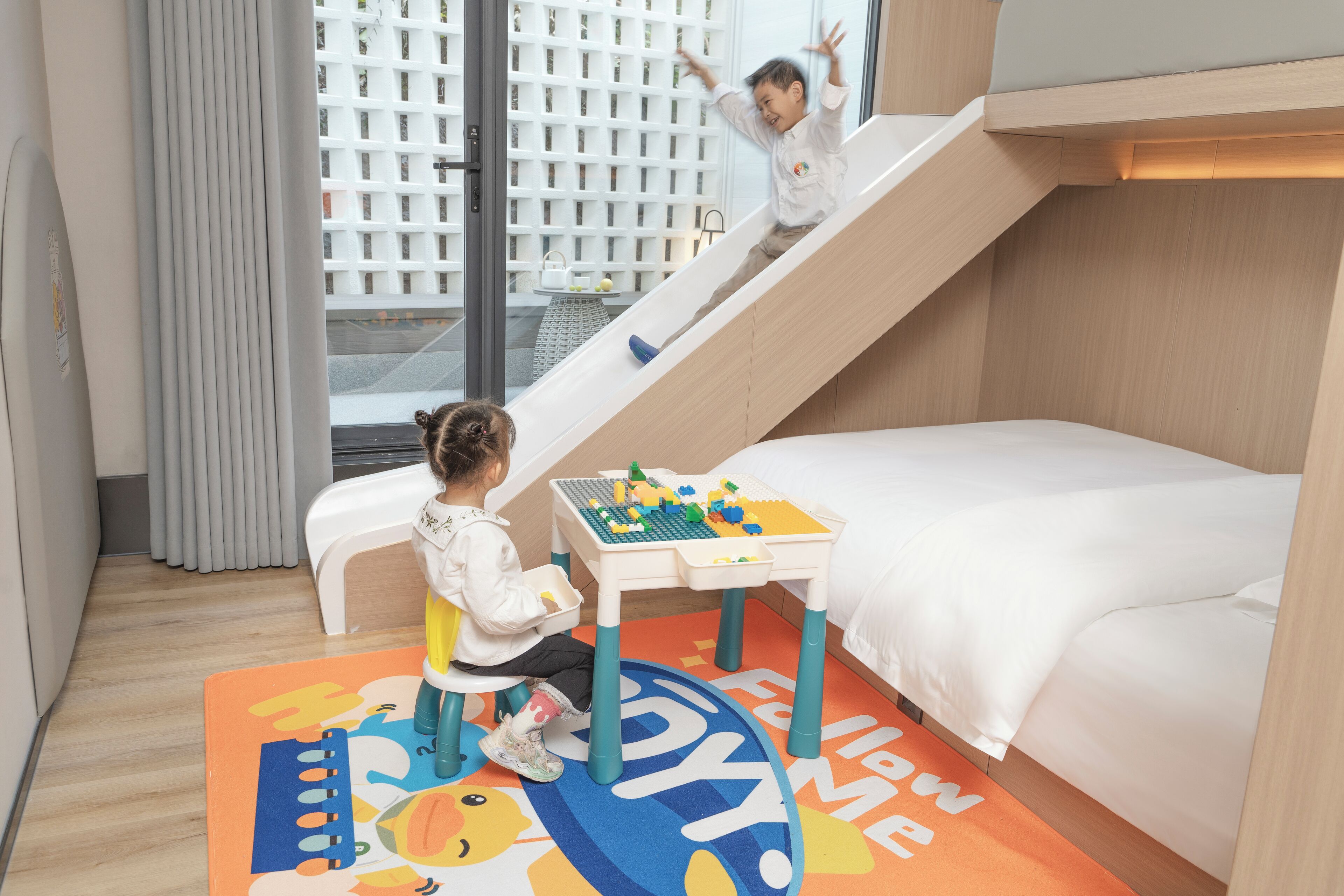 A children's play area with a slide and a table with building blocks.