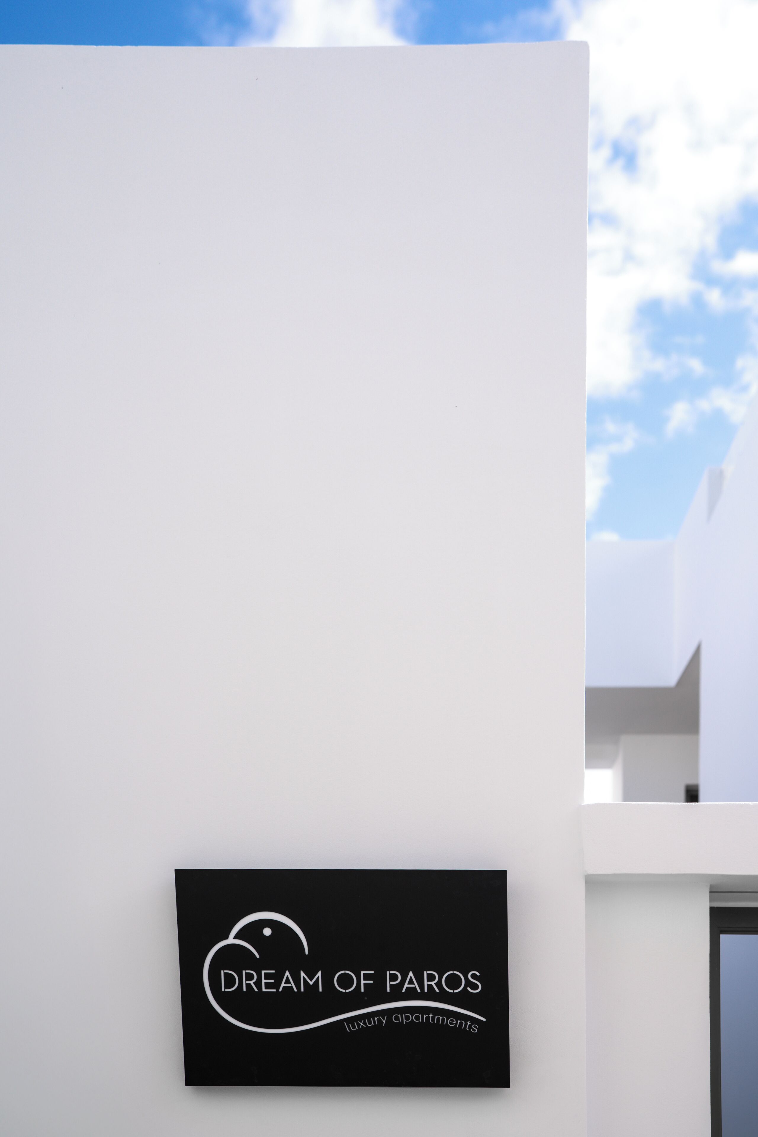 A sign for 'Dream of Paros' luxury apartments.
