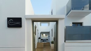 A modern building with a sign reading "Dream of Paros." - Dream of Paros by GHH (Paros)