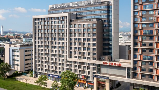 A modern hotel building with multiple floors, large windows, and a prominent sign at the top. - Lavande Hotel - Huizhou Boluo Shiwan (Huizhou)