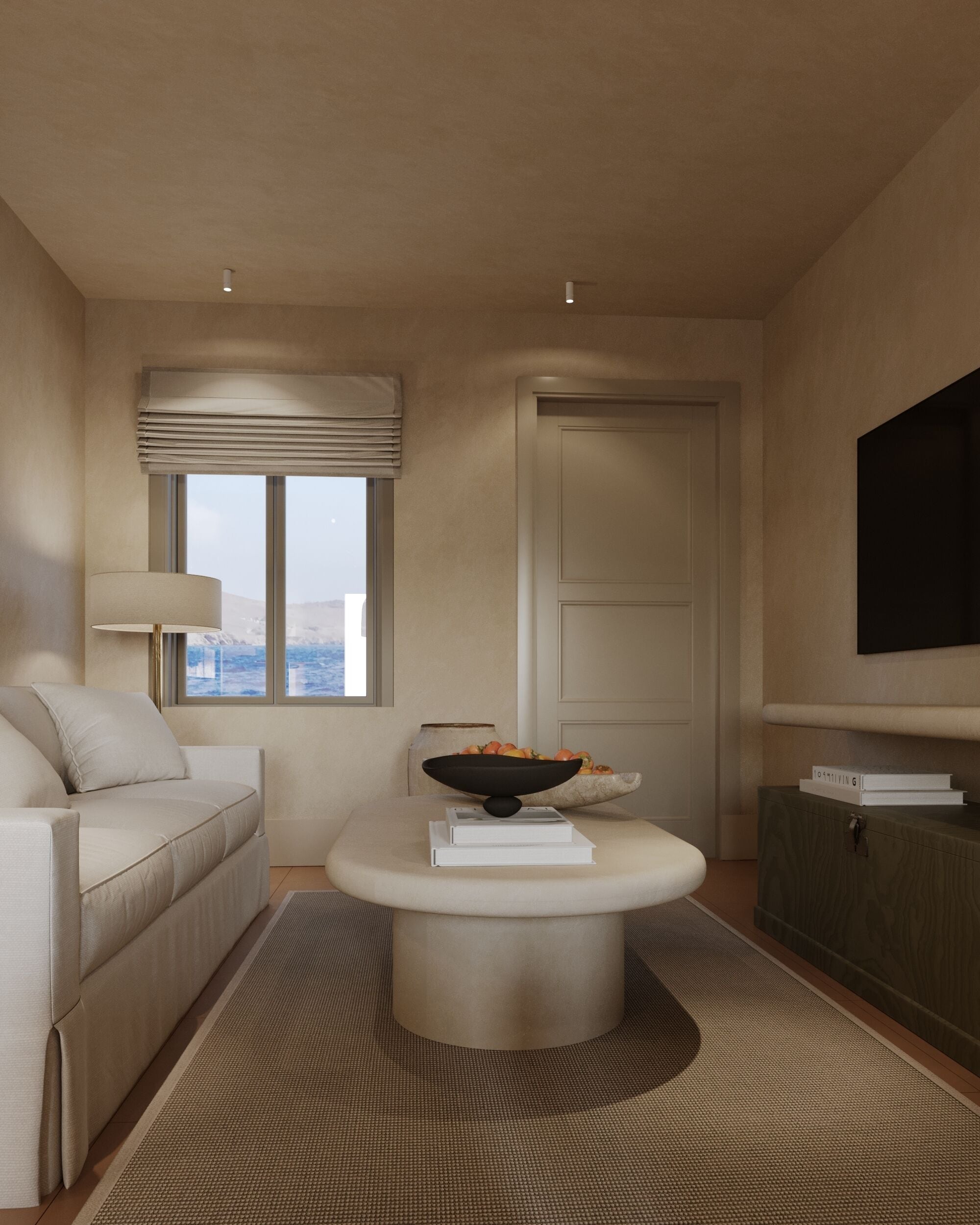 A modern living room with a sofa, a coffee table, a bowl, and a flat-screen TV mounted on the wall.