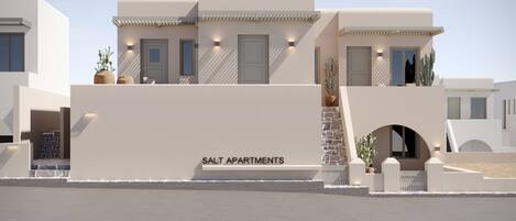 A modern building with a flat roof, a large entrance, and a sign that reads "SALT APARTMENTS."