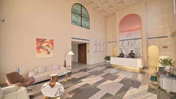 A spacious lobby with a reception desk, a large arched window, and a modern interior design. - Tree of Life Ganga Dwar, Haridwar (Haridwar)