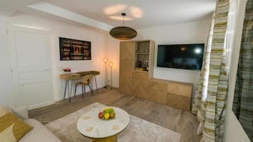 Suite Deluxe | Zona de estar | Una televisión de pantalla plana