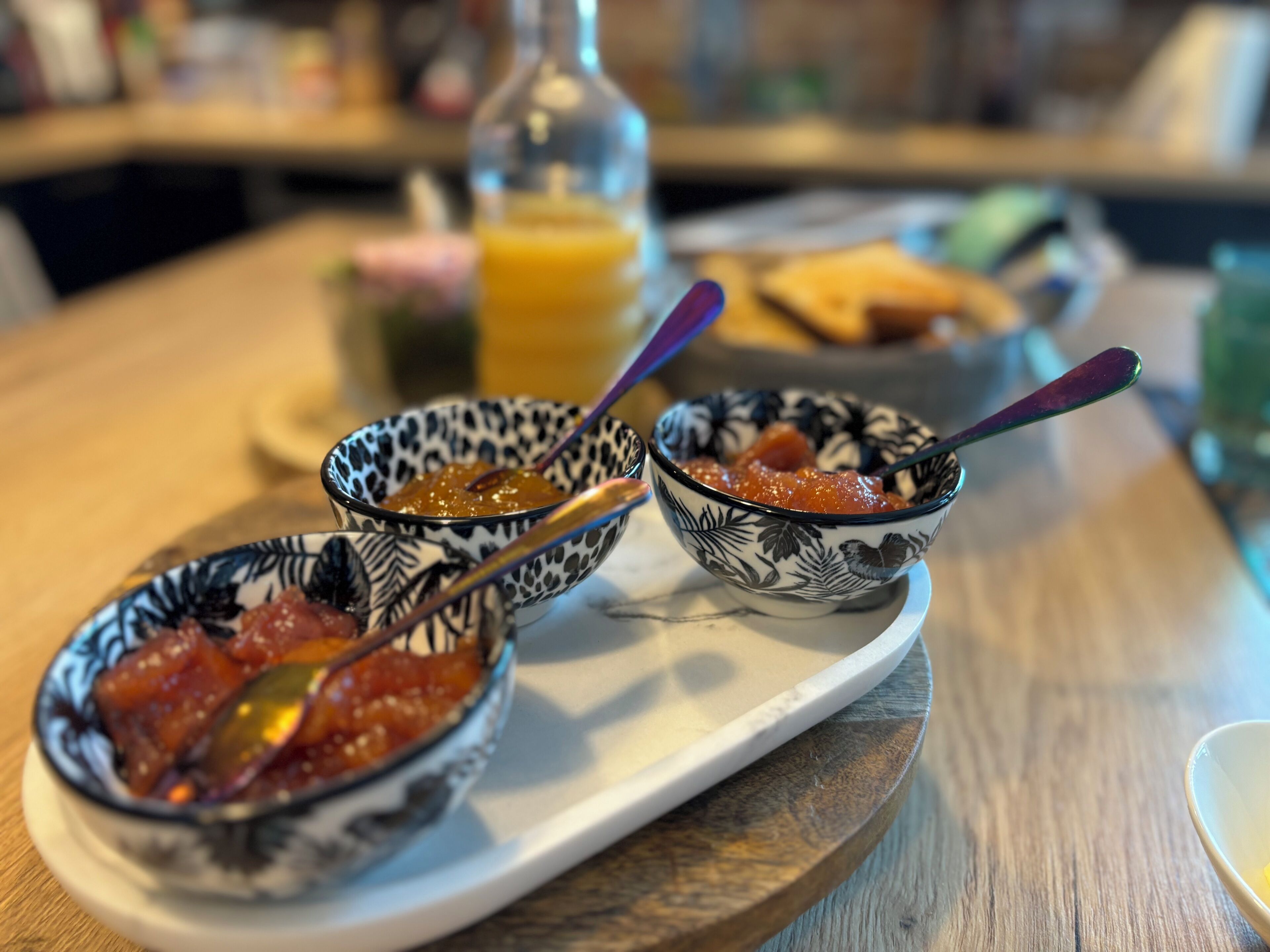 Three bowls of food on a tray.