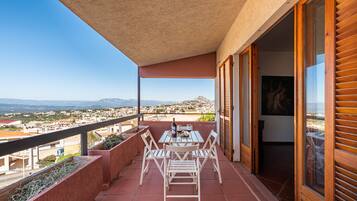 Enjoy dining or socializing on this balcony with a scenic view of the town and distant mountains.