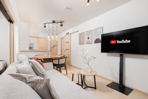 Classic Apartment | Living area | 50-inch flat-screen TV with cable channels