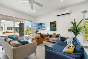 Relax in this stylish living room with a sofa, coffee table, and wall-mounted TV.