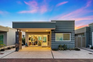 Enter a welcoming space through the glass door into a well-lit interior.