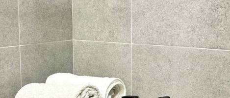 Shower, hair dryer, towels, soap