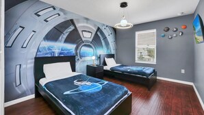 A bedroom with two beds, a mural of a space shuttle, a window with blinds, and a wall with decorative items. - 4736 Family Home Near Disney Sea World (Kissimmee)