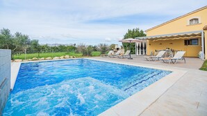 A swimming pool with lounge chairs and a covered patio area. - Villa Can Paxaco - By Dream Villas Pollensa (Alcudia)