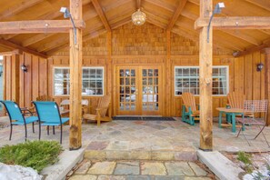 A wooden cabin with a stone patio, wooden chairs, and a wooden table. - Views + Trail Access: Scenic Montana Ranch Retreat (Emigrant)
