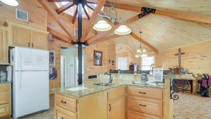 A spacious kitchen with wooden cabinets, a granite countertop, and a large island. - Fire Pit, Views: Lakefront Toledo Bend Retreat! (Many)