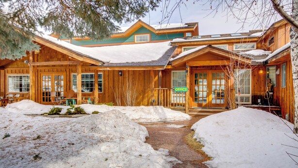A wooden lodge with a snow-covered entrance and a clear path leading to the main building. - Spacious Yellowstone River Retreat w/ Trails! (Emigrant)